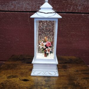 Lighted lantern displaying ""Now in God's arms"